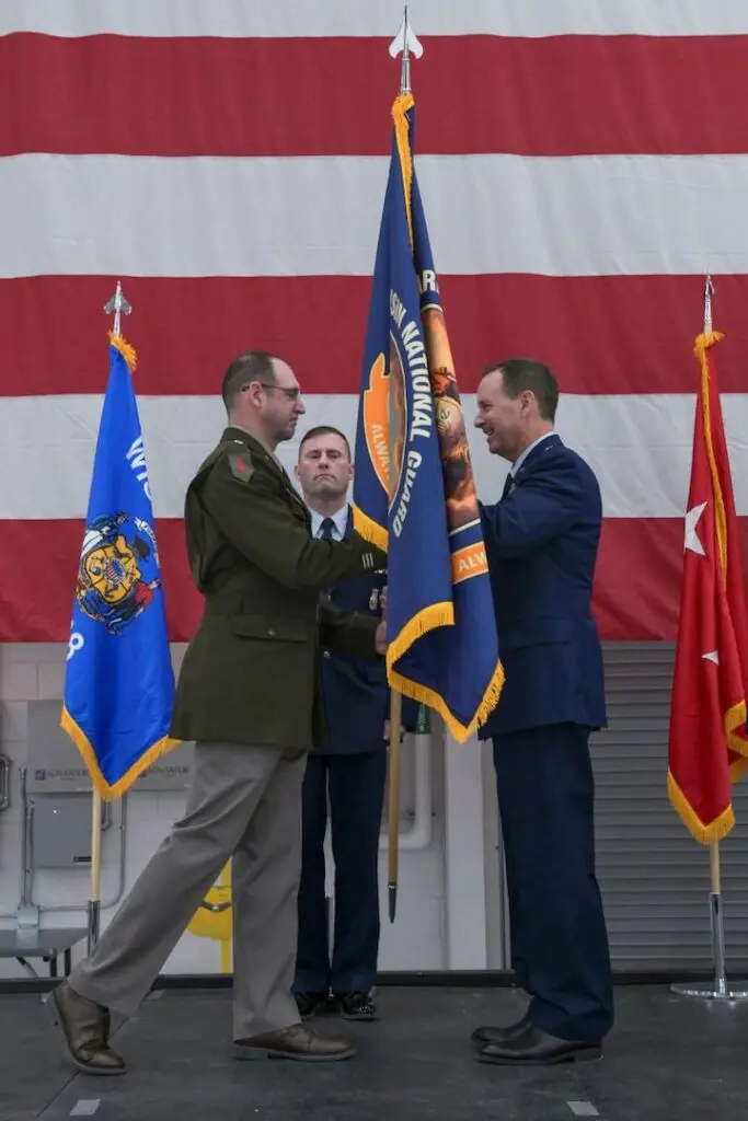 Two senior guards men shaking hands on stage