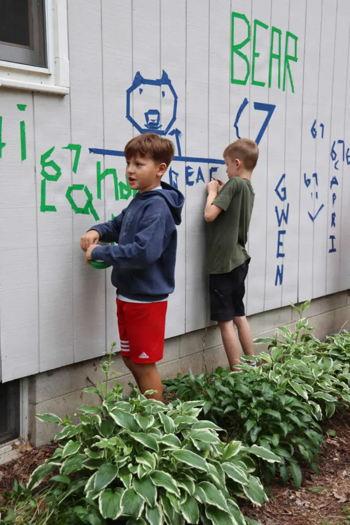 Two campers decorating the troop cabin at the Wisconsin National Guard’s Badger Youth Camp at Camp Lakotah.