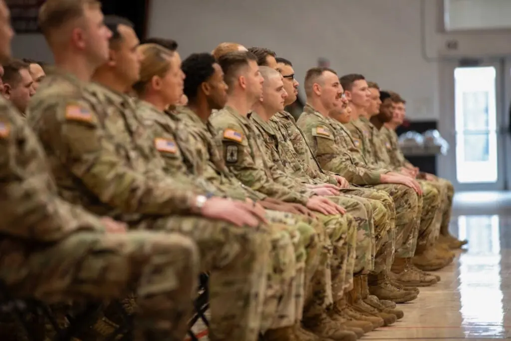 A group of people watching a ceremony in an auditorium