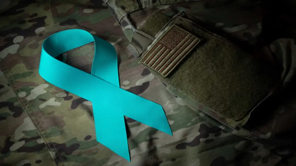 A teal ribbon on a military uniform