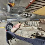A fragment of U.S. Army Air Forces Maj. Richard I. Bong’s P‑38 Lightning aircraft in an aircraft hanger.