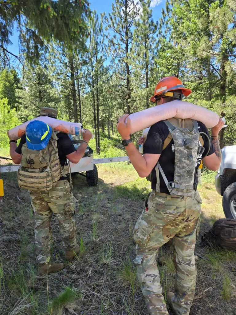 Soldiers carrying explosives in the forest