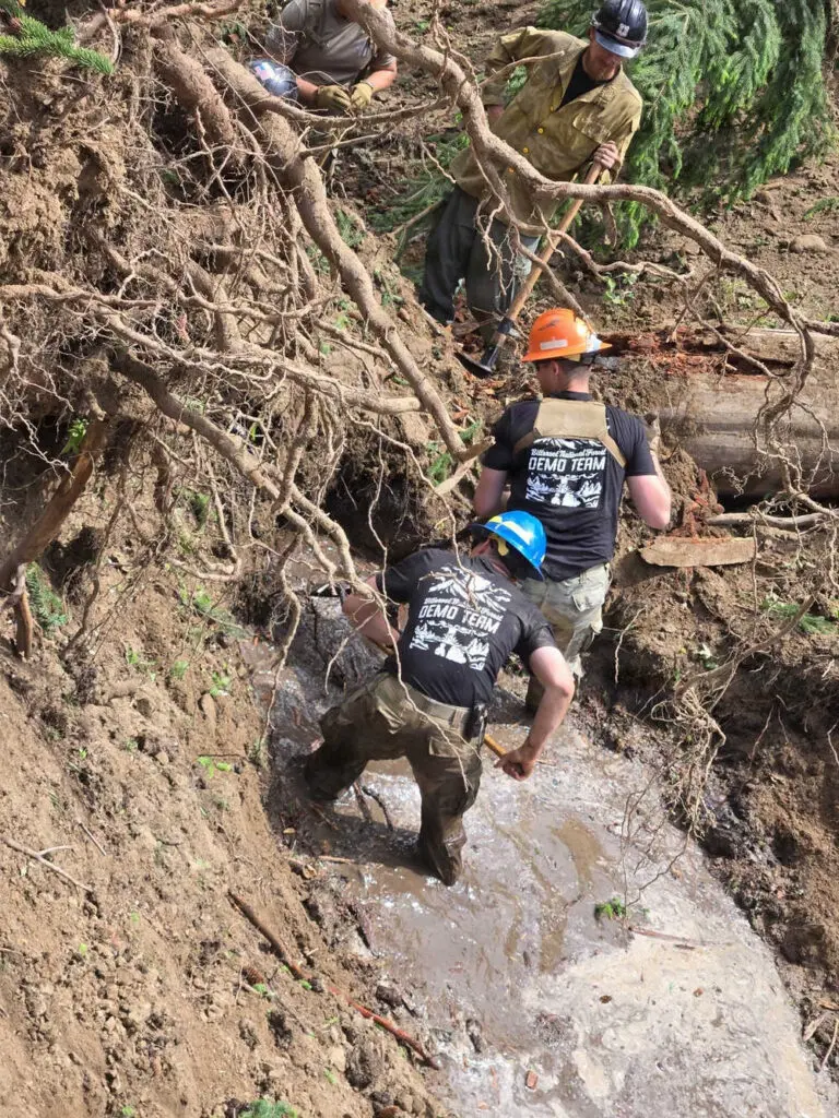 a group working to clear a water way after using explosives