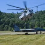 A helicopter ready to lift an F-15