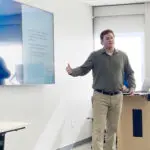 A presentation in front of of a screen