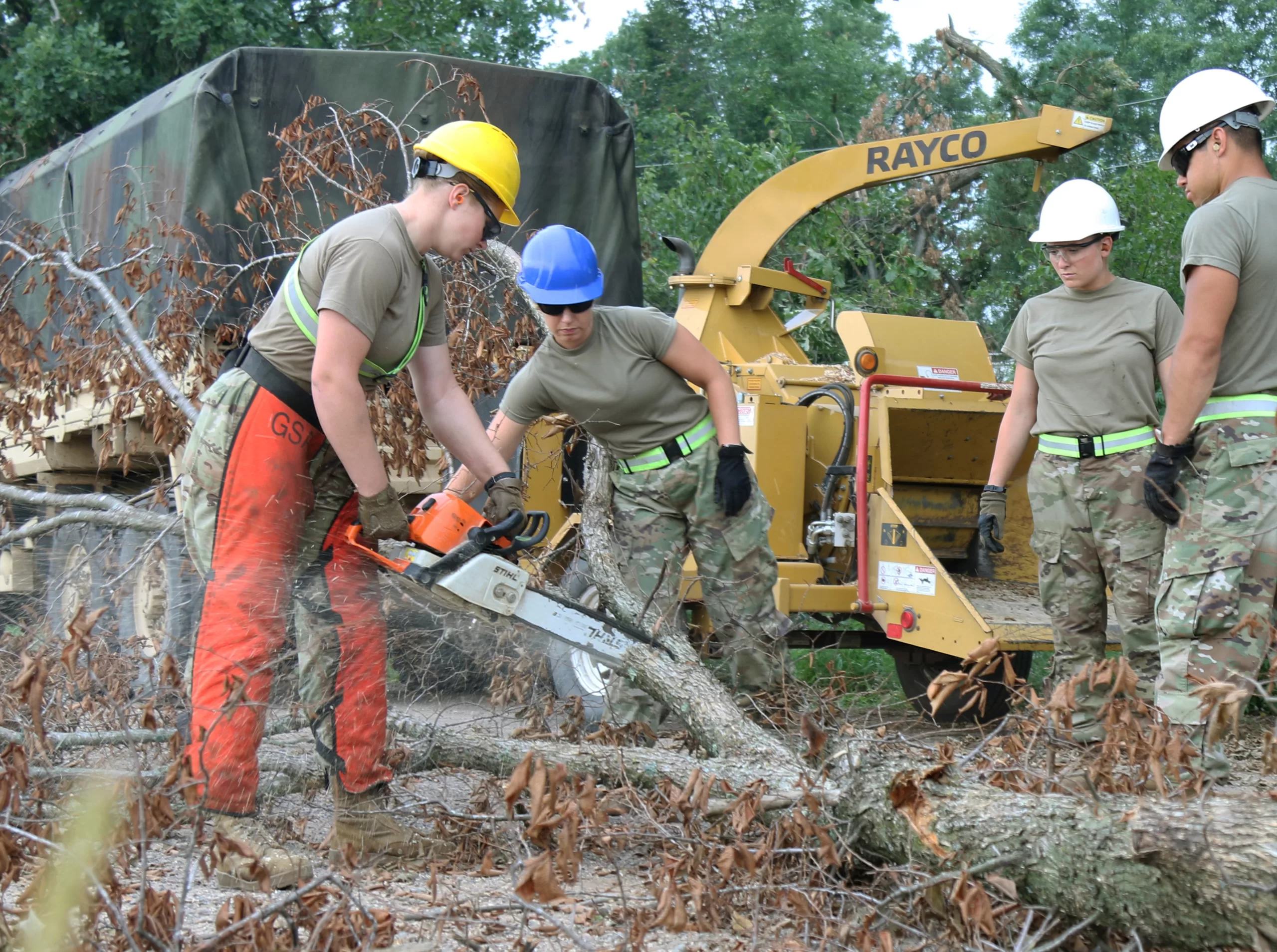 A team of Soldiers with the Wisconsin Army National Guard cut and chip debris, clearing roadways in Balsam Lake, Wis., Aug. 5. Approximately 100 Soldiers and Airmen from the Wisconsin Army and Air National Guard continue to assist civil authorities with damage assessment and debris clearance in Polk and Barron Counties after being mobilized to state active duty to support recovery efforts following the severe weather that struck Northern Wisconsin July 19-20. (112th Mobile Public Affairs Detachment photo by Staff Sgt. Alexandria Hughes/Released)