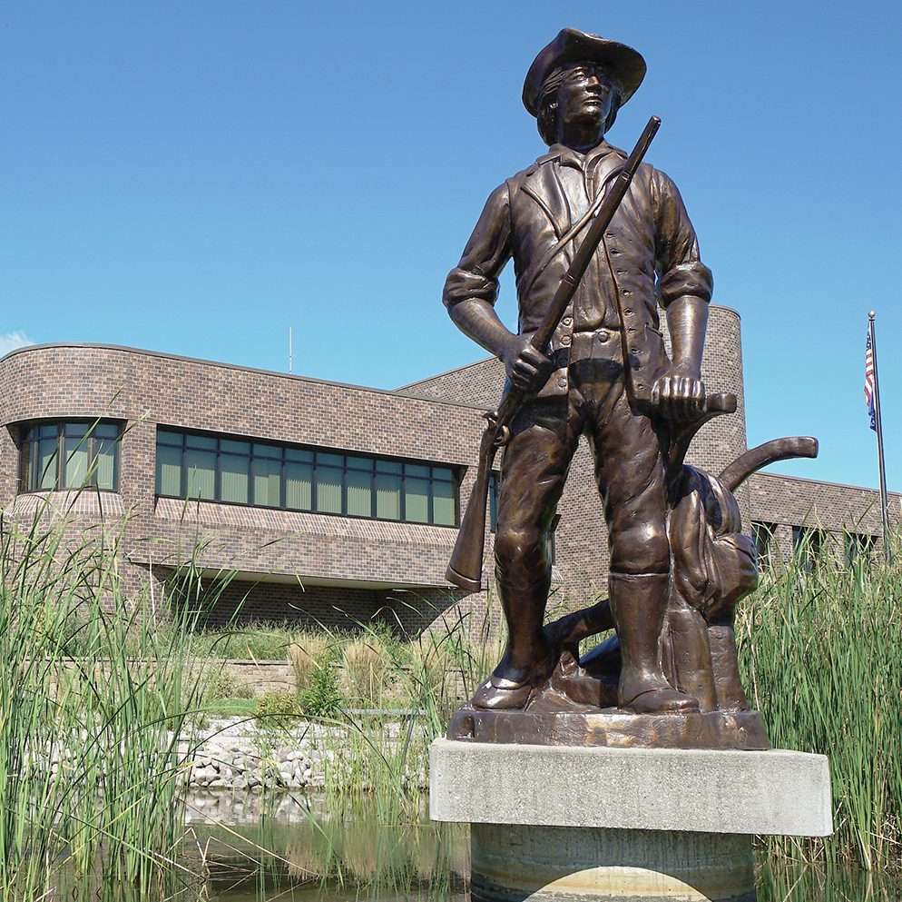 The minuteman statue in front of the JFHQ building