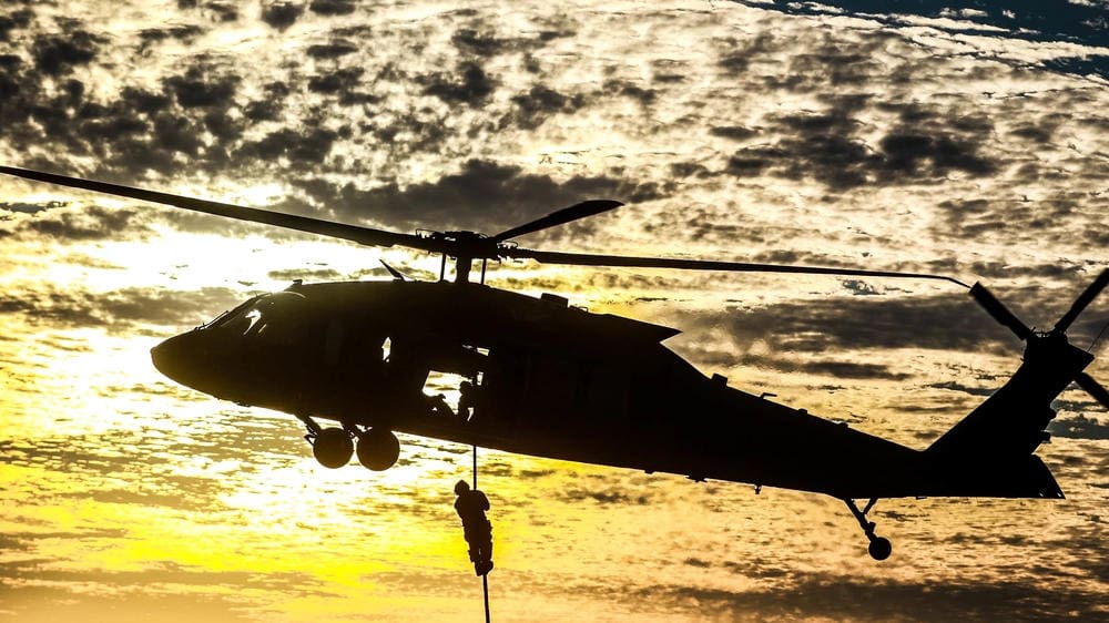 Personnel repelling down from a UH-60 Blackhawk Helicopter