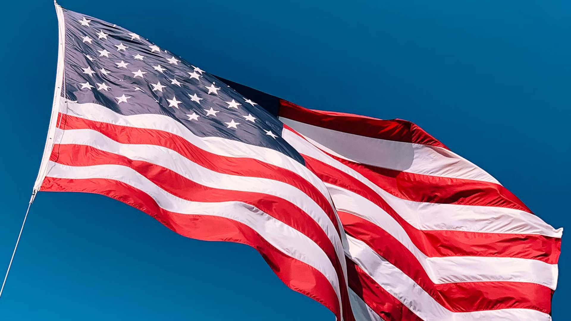 A US Flag being lowered