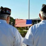 Veterans watching a flag lowering