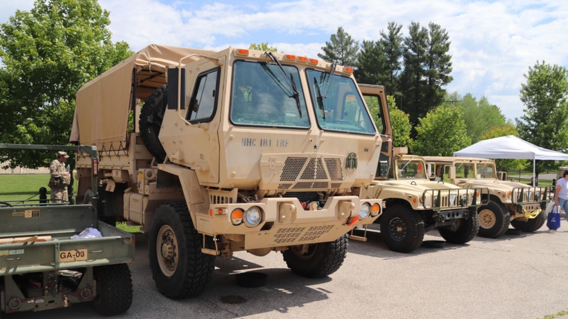 A line of parked vehicles at an open house event