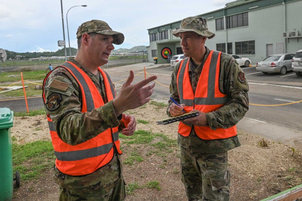 Two people talking about issues while taking notes