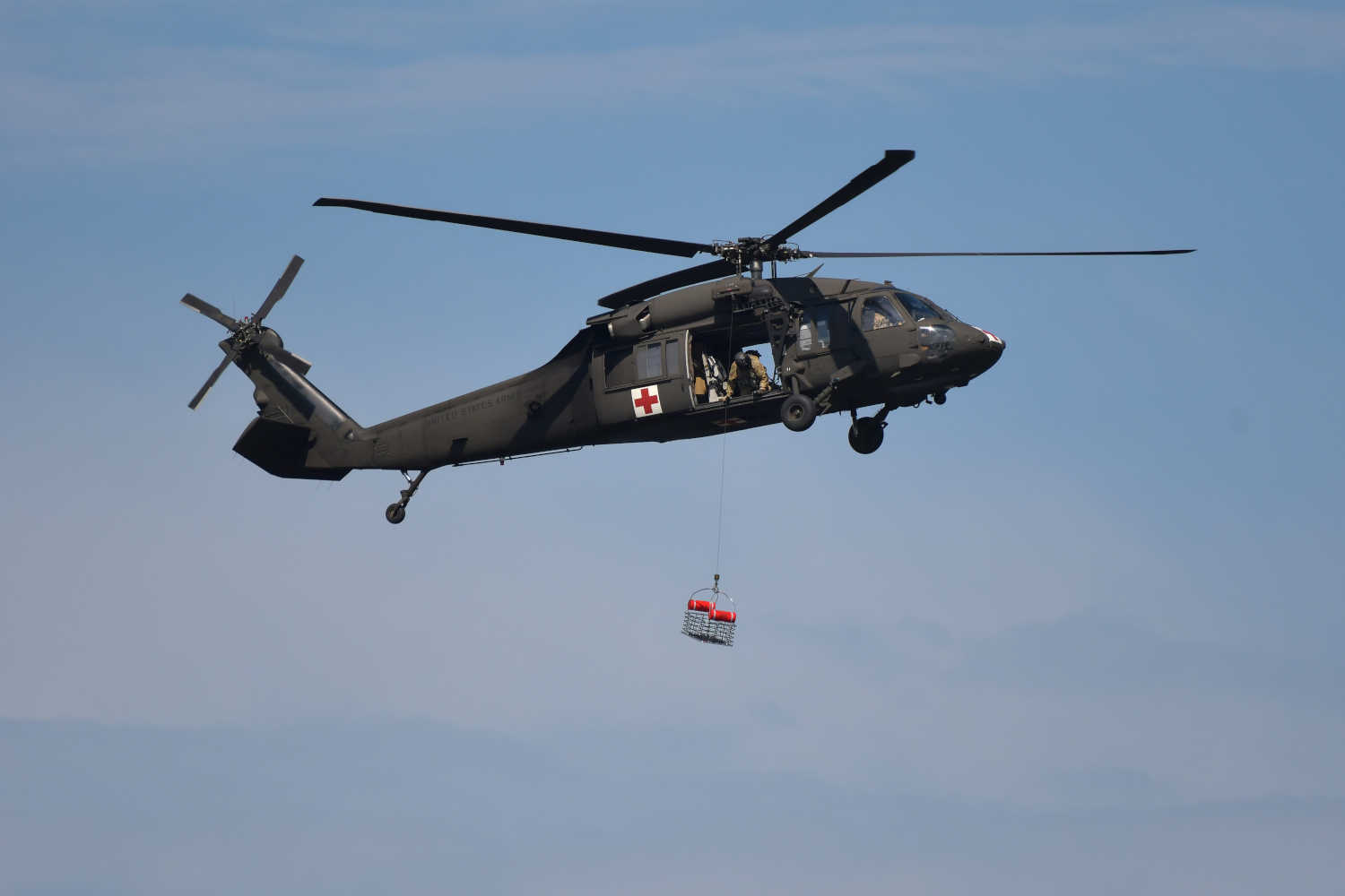 A helicopter carrying a recuse basket