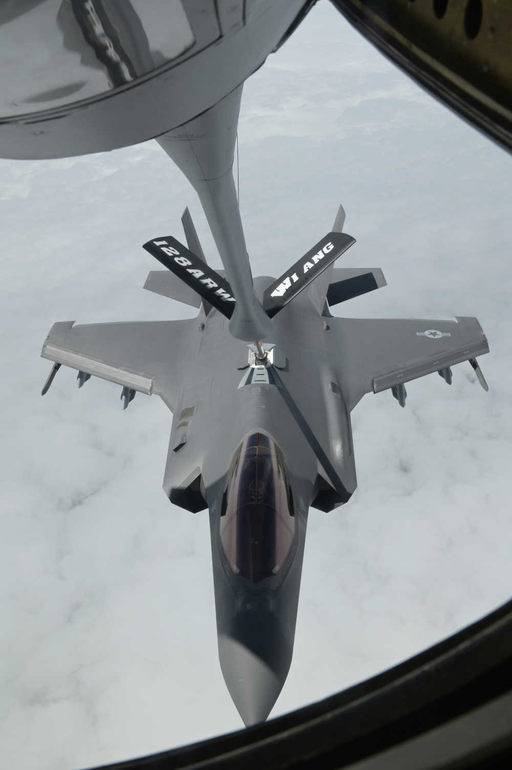 Looking down at a pain being refueled mid air