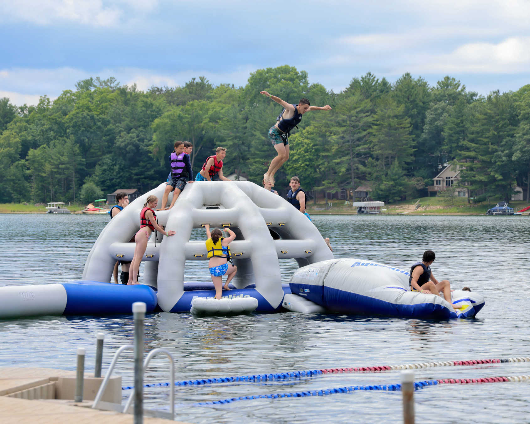 Campers jumping off a lake float at the Wisconsin National Guard’s Badger Youth Camp at Camp Lakotah.