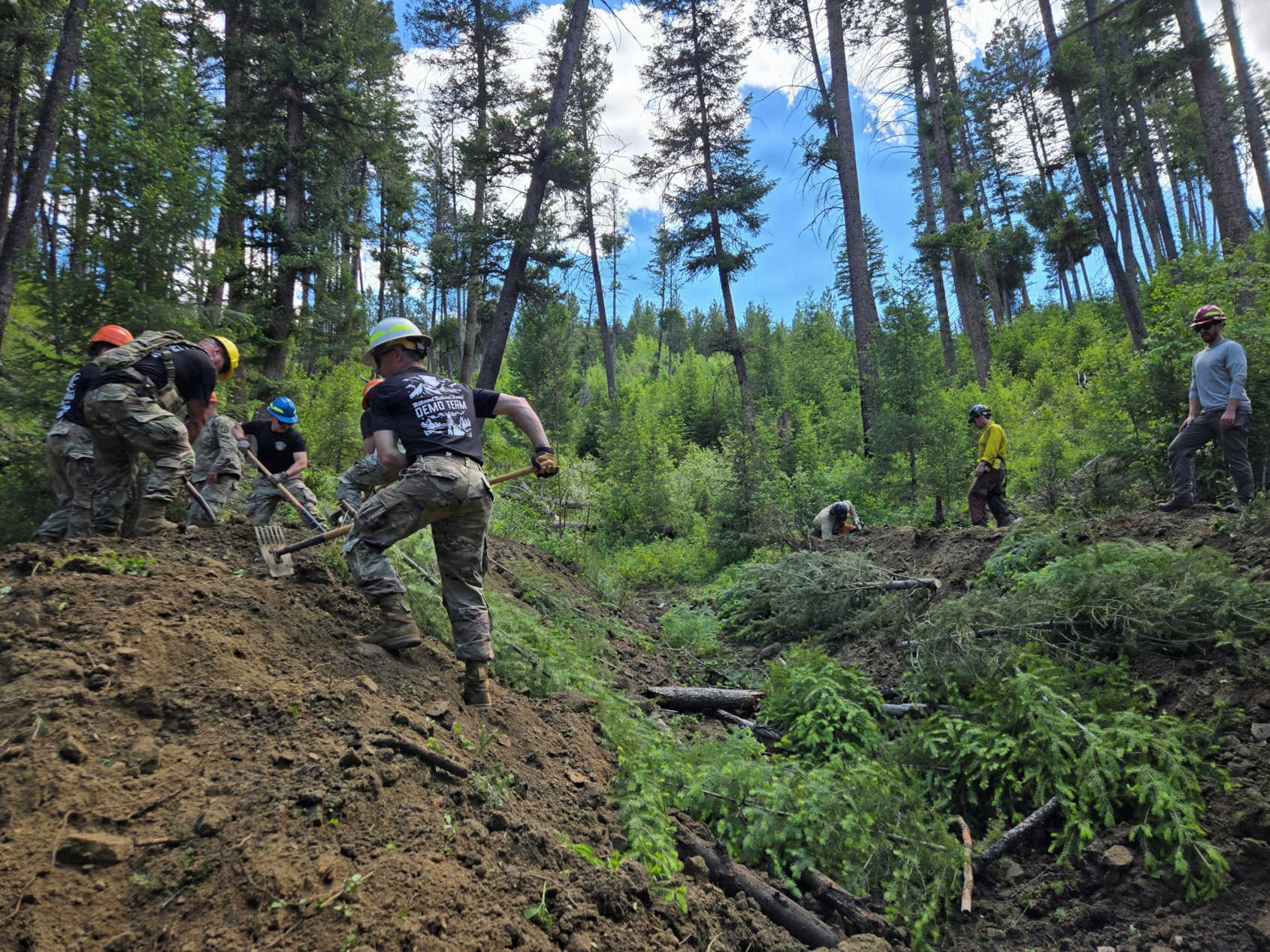 crews moving dirt and debris from a culvert