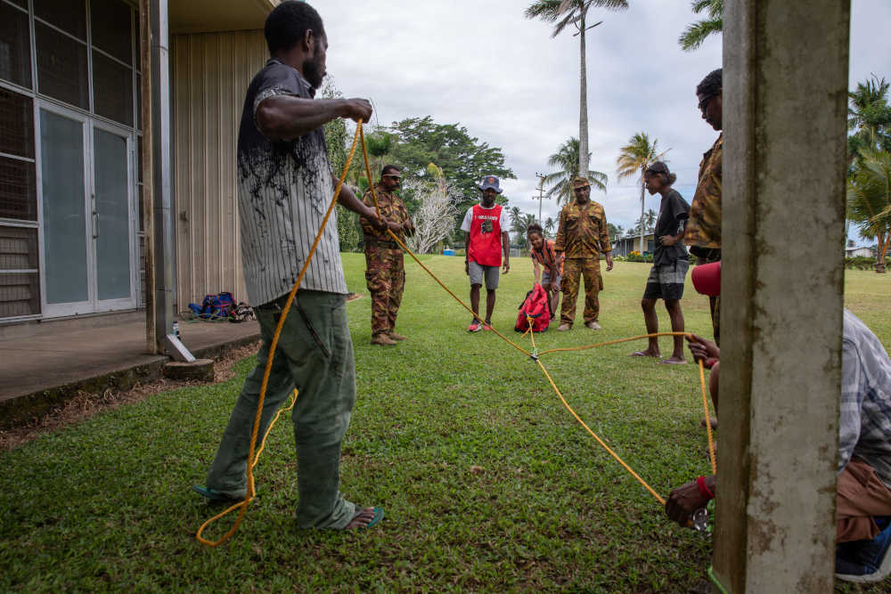 Seven people working with ropes