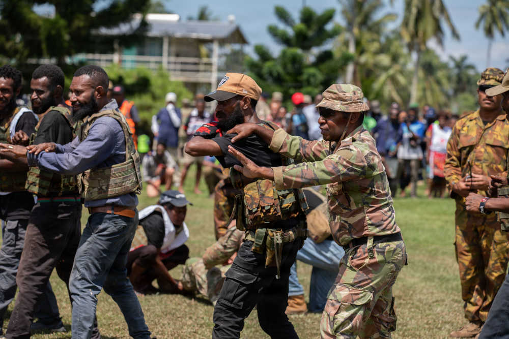 people working across a field while they are training