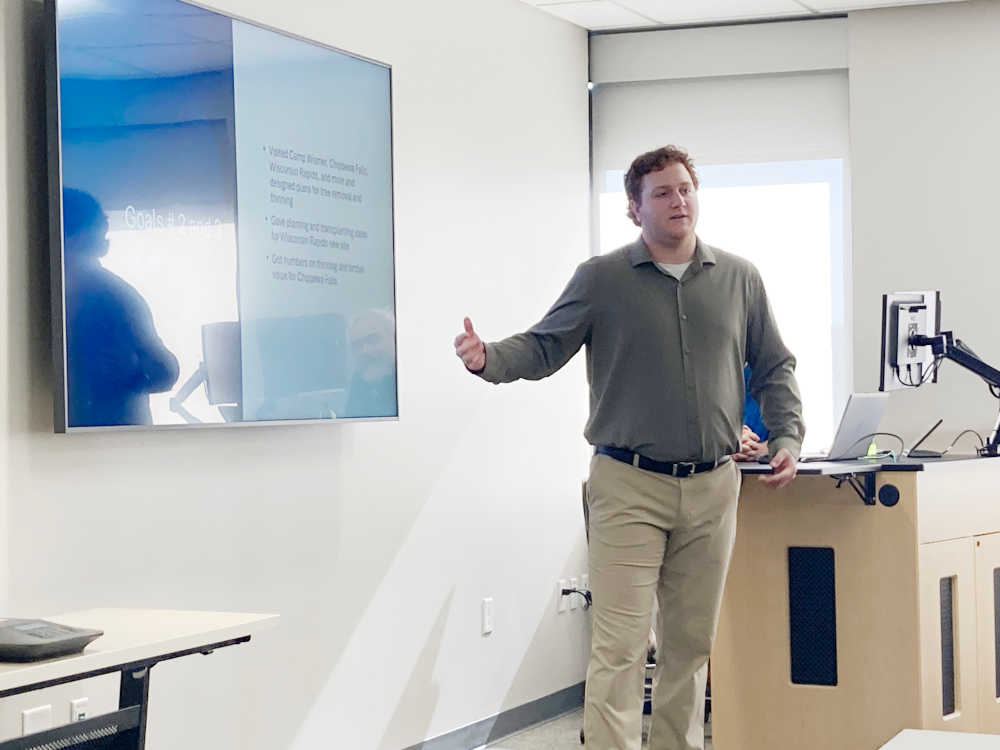 A presentation in front of of a screen