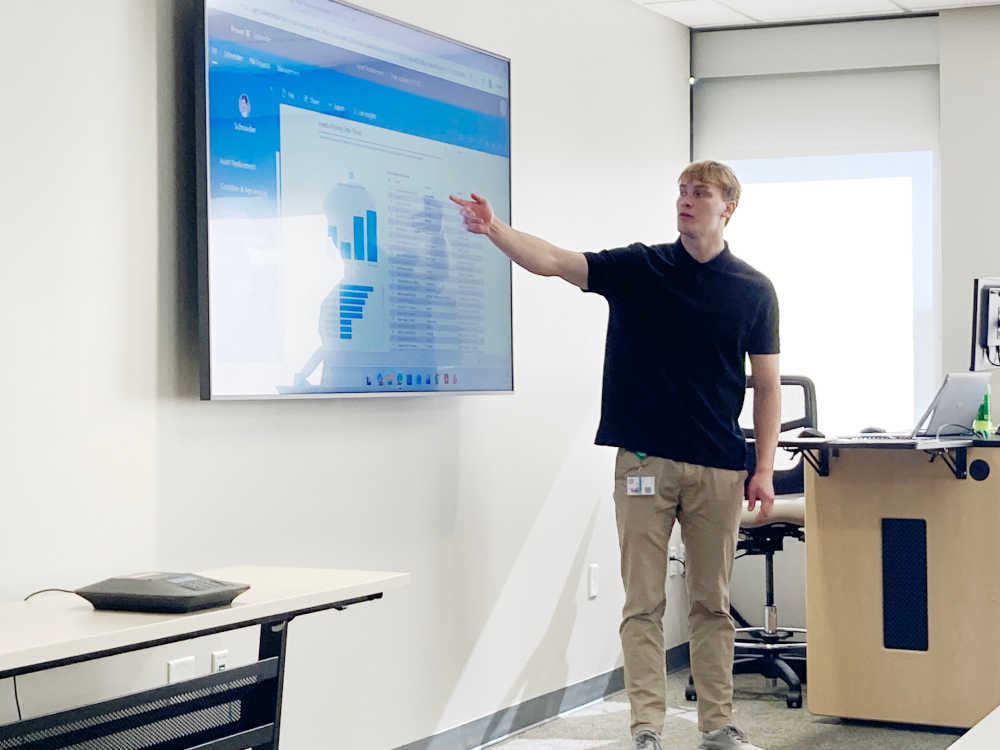 Giving a presentation in front of of a screen while pointing