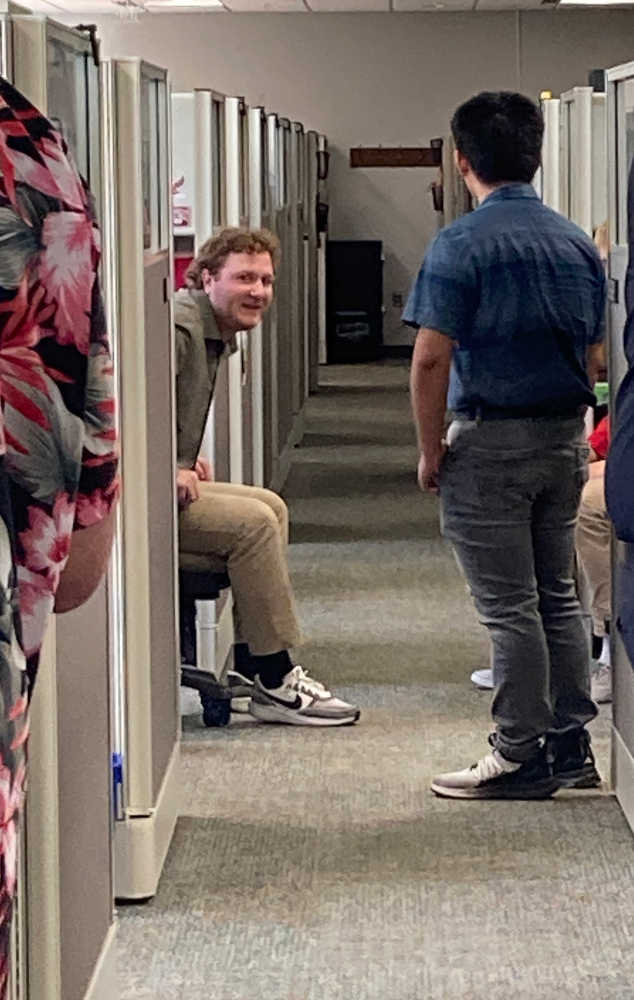 Workers talking together from their cubicles