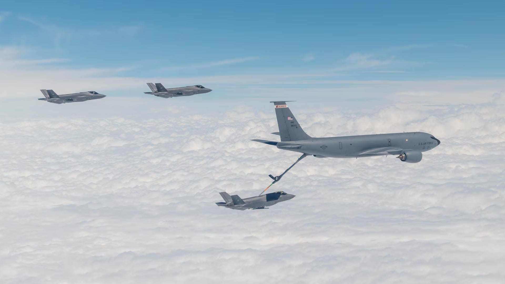 F-35s flying next to and getting filled by a KC-135 Stratotanker