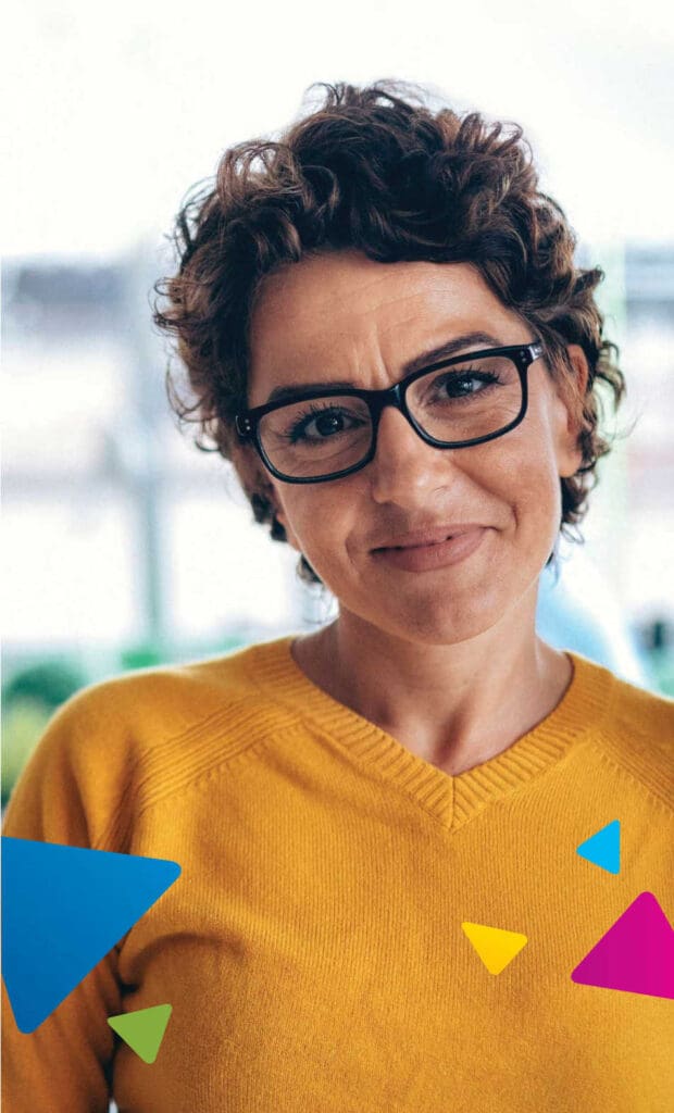 A smiling person with glasses