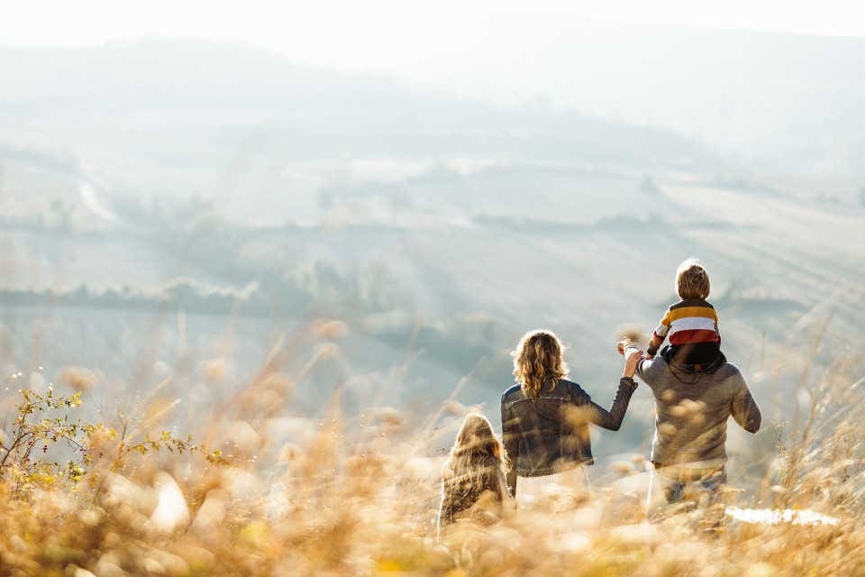 A family on a hike looking out over the landscape